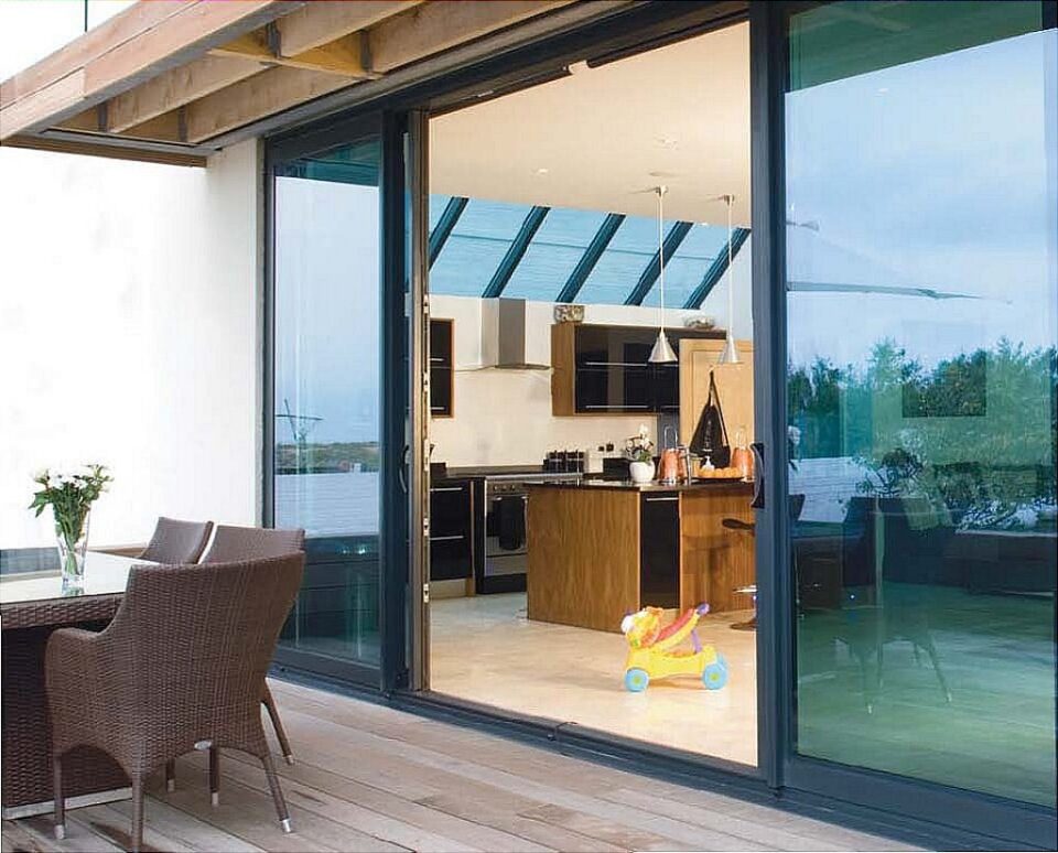 Aluminium sliding doors from a kitchen-diner onto a deck