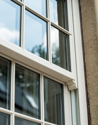 Close-up of a decorative sash horn on a white sliding sash window