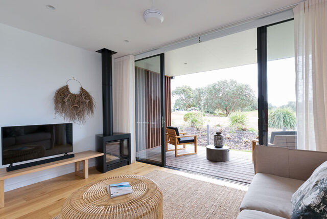 Sliding patio doors open onto a terrace from a bright living room