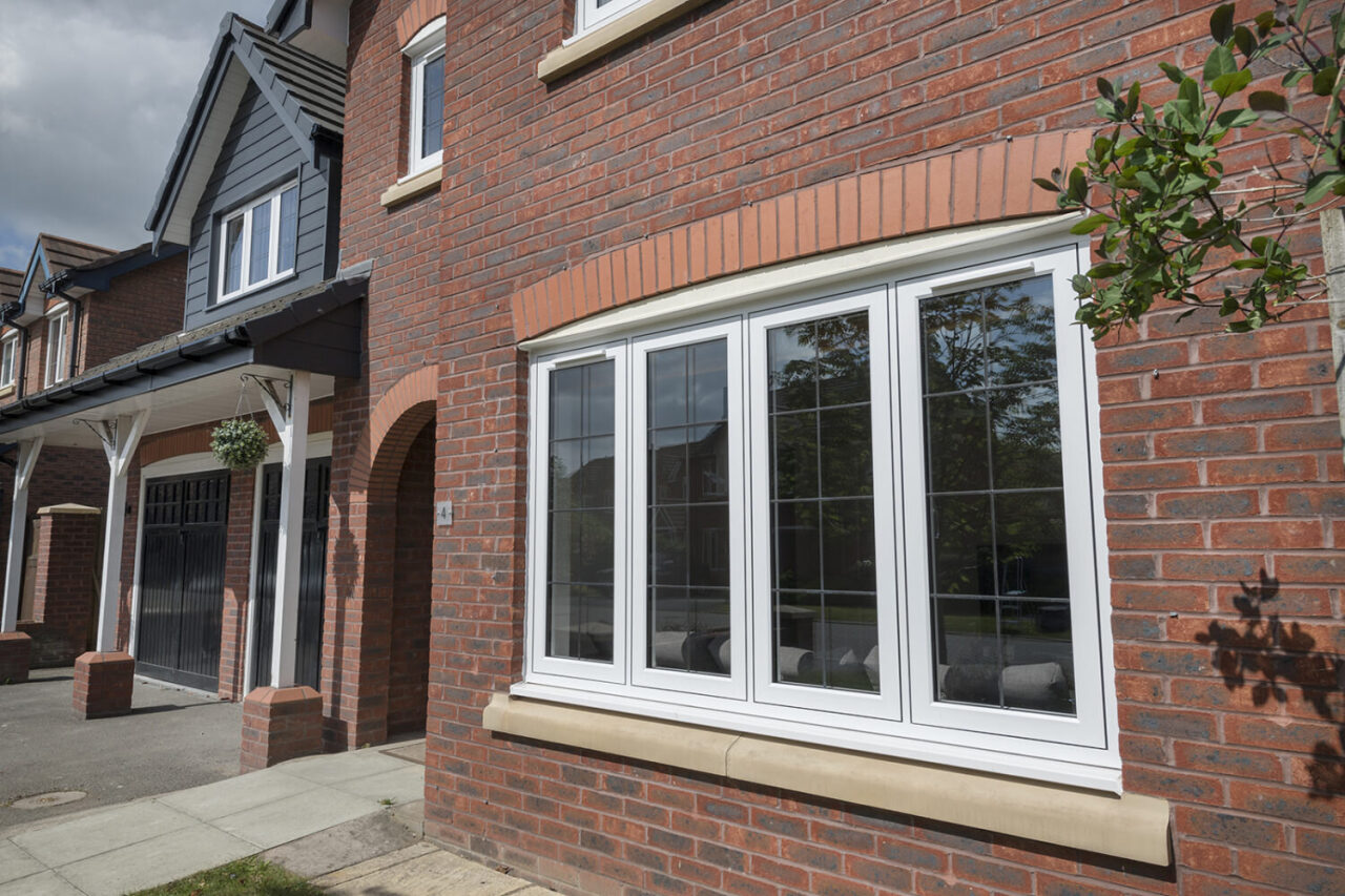 White VEKA M70 PVCu casement windows on a new-build brick house