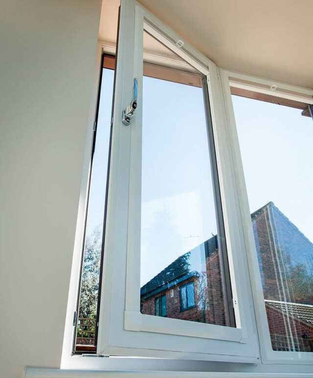 Close-up of an open white PVCu casement window showing the multi-chamber frame