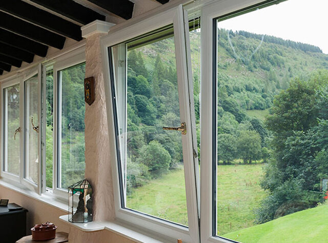VEKA M70 window opened inwards with a view over a wooded valley